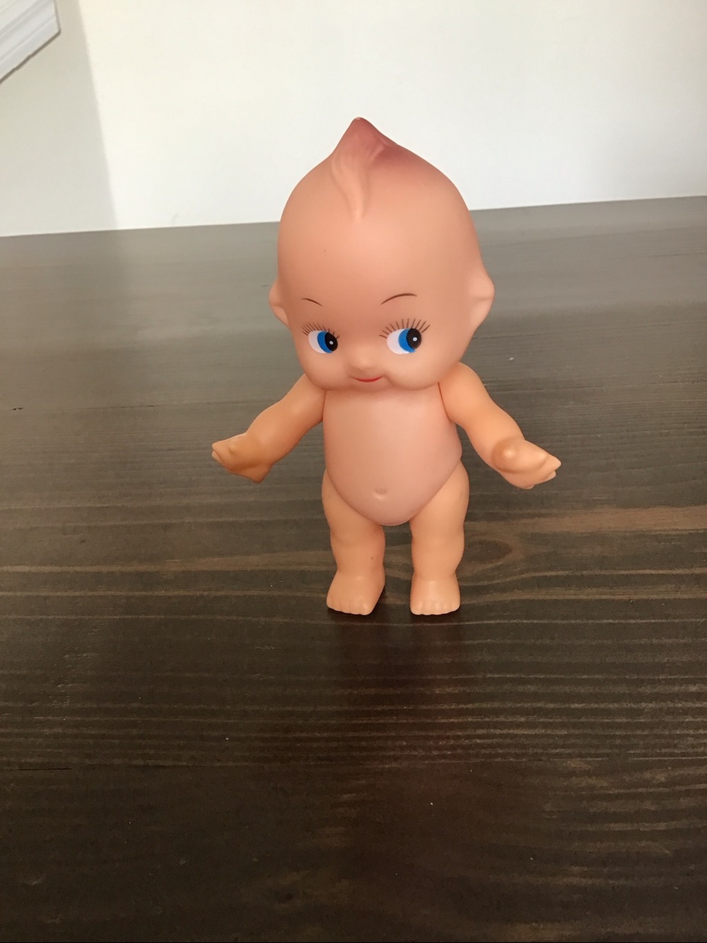 Vintage unmarked 6-inch hard plastic Kewpie doll from the mid-century era